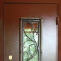Металлическая дверь с окном и кованой решеткой